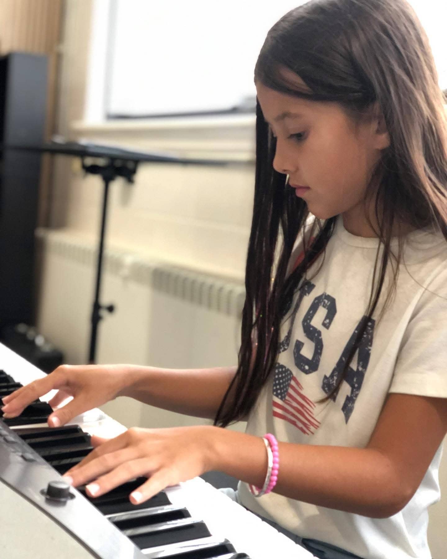 Student focused on keyboard practice during NYSSMA SCMEA MYO audition prep at Michael Mingoia Music in Patchogue, NY