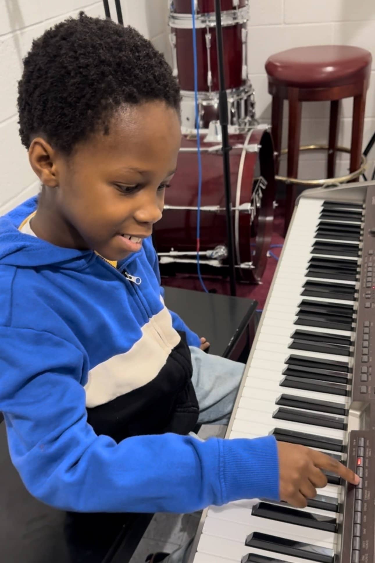Young student learning keyboard at Michael Mingoia School of Music in Patchogue, NY