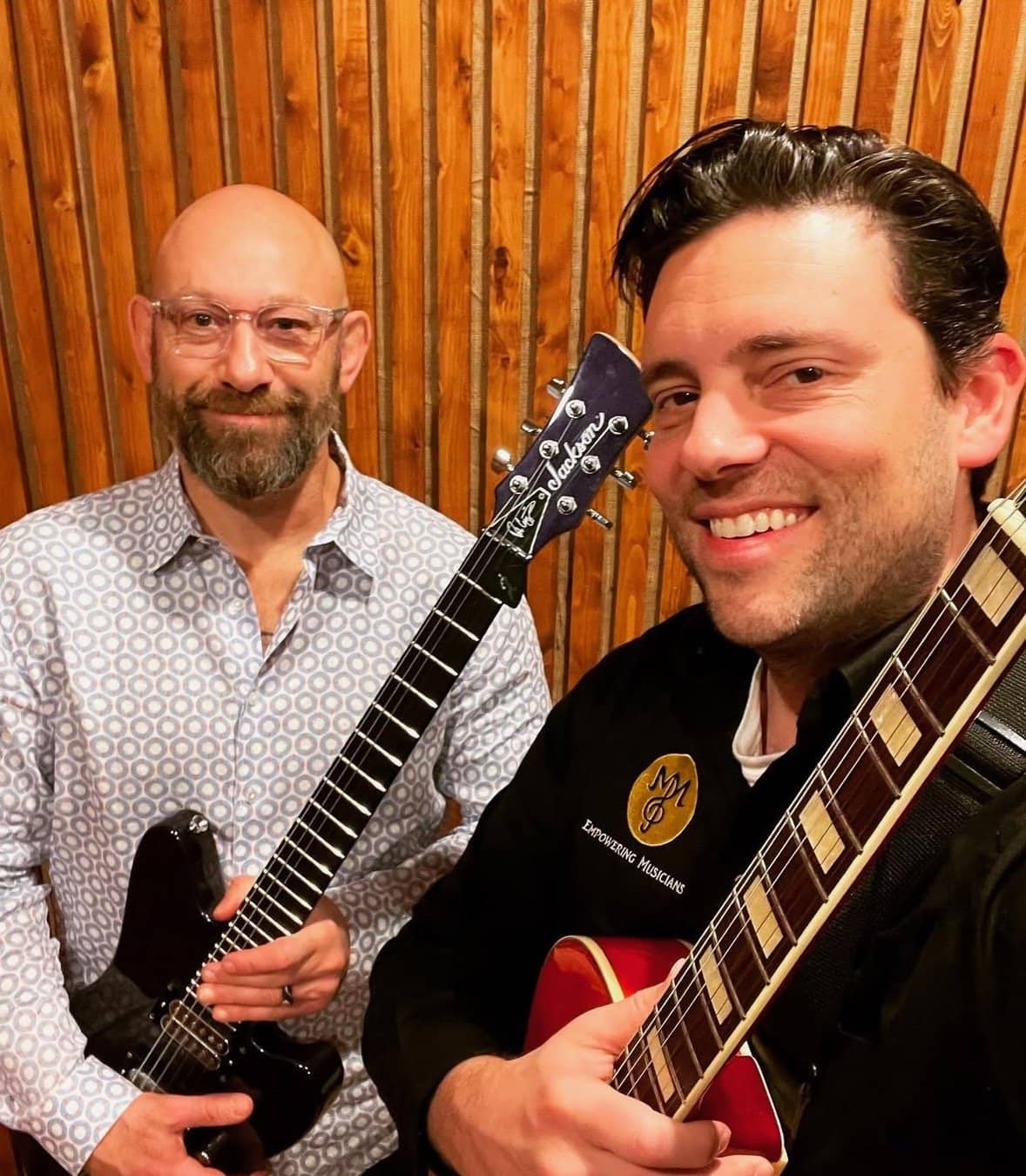 Michael Mingoia and a student with acoustic guitars at M3 Studios in Patchogue, NY
